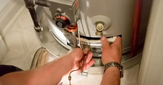 Man fixing a water heater